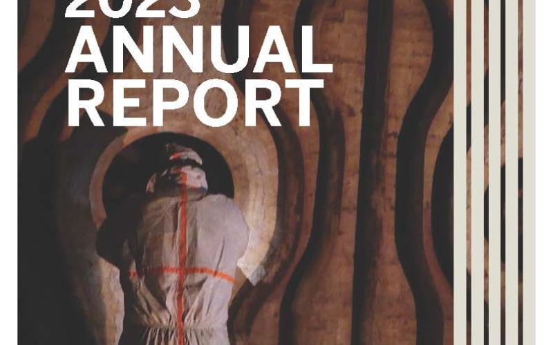 Front cover of the 2023 Environmental Health and Safety Annual Report showing a Safety Specialist performing an asbestos survey inside a boiler.